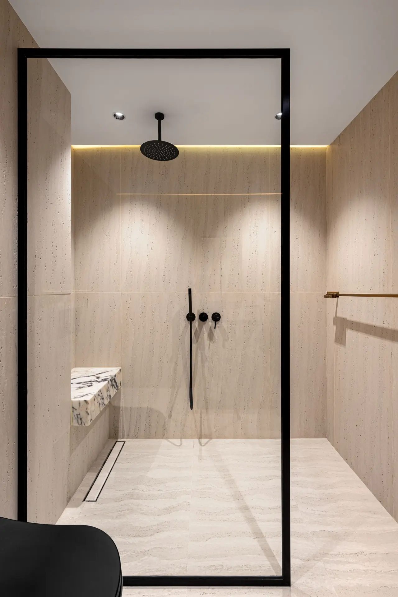 Curbless shower with linear drain and frameless glass panel