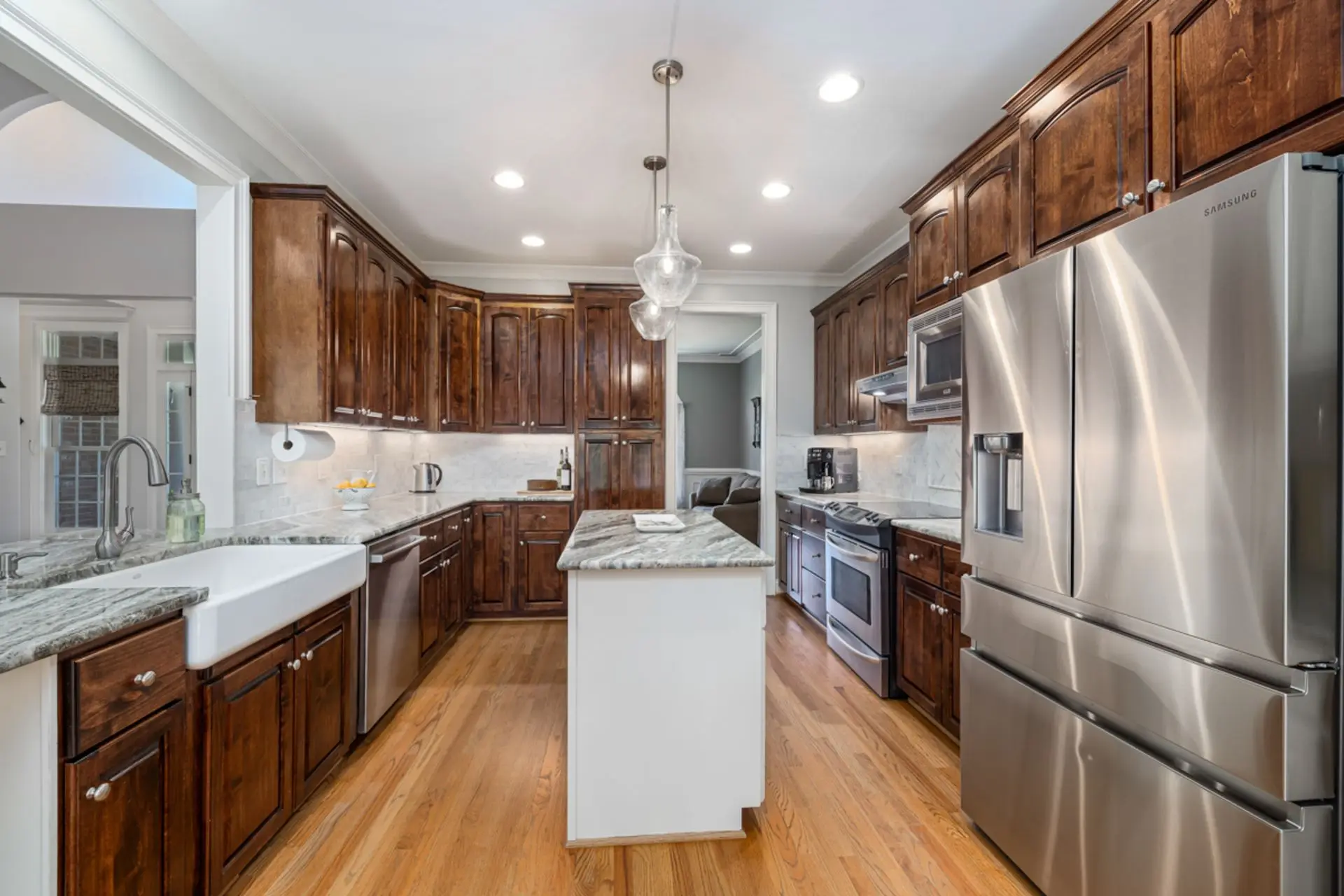 Kitchen remodel with warm wood cabinets, stainless appliances and island